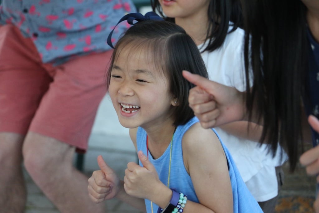 A camper giving two thumbs up at Camp Korey, the SeriousFun camp in Washington