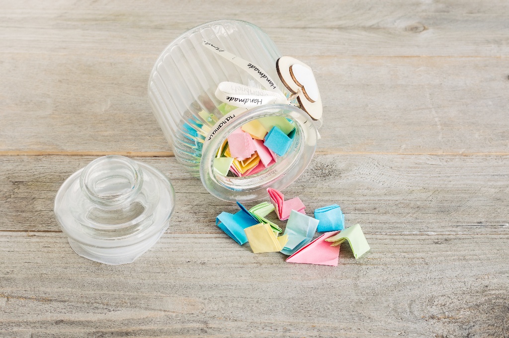 Jar filled with colorful pieces of paper