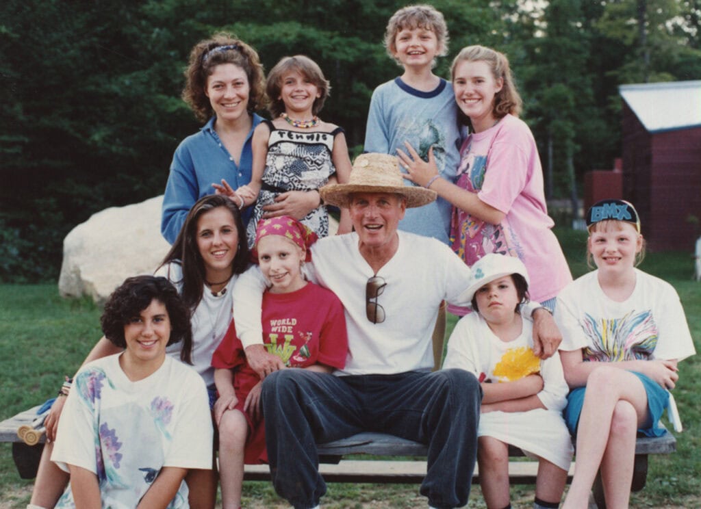 Paul Newman surrounded by SeriousFun campers pose for a photo.